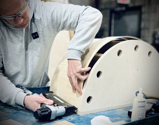 Member working on a wooden project with power tools