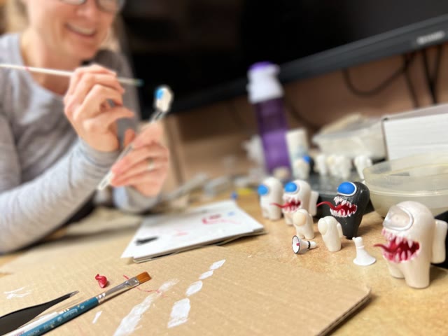 Member painting a project at a Protospace work table